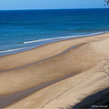 overhead view of brown sand and blue ocean water view