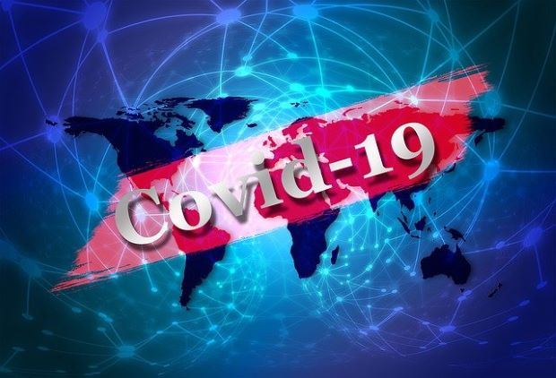 the word covid-19 over a map of the world