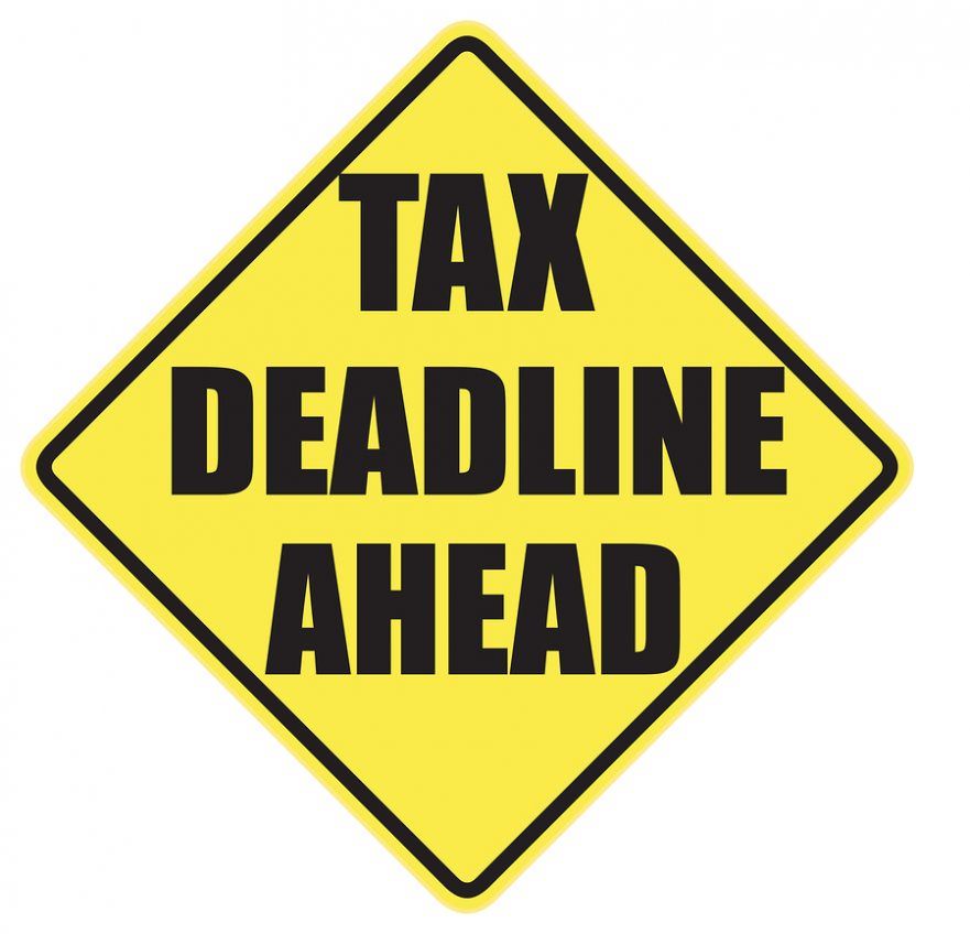 road sign art graphic text reading tax deadline ahead