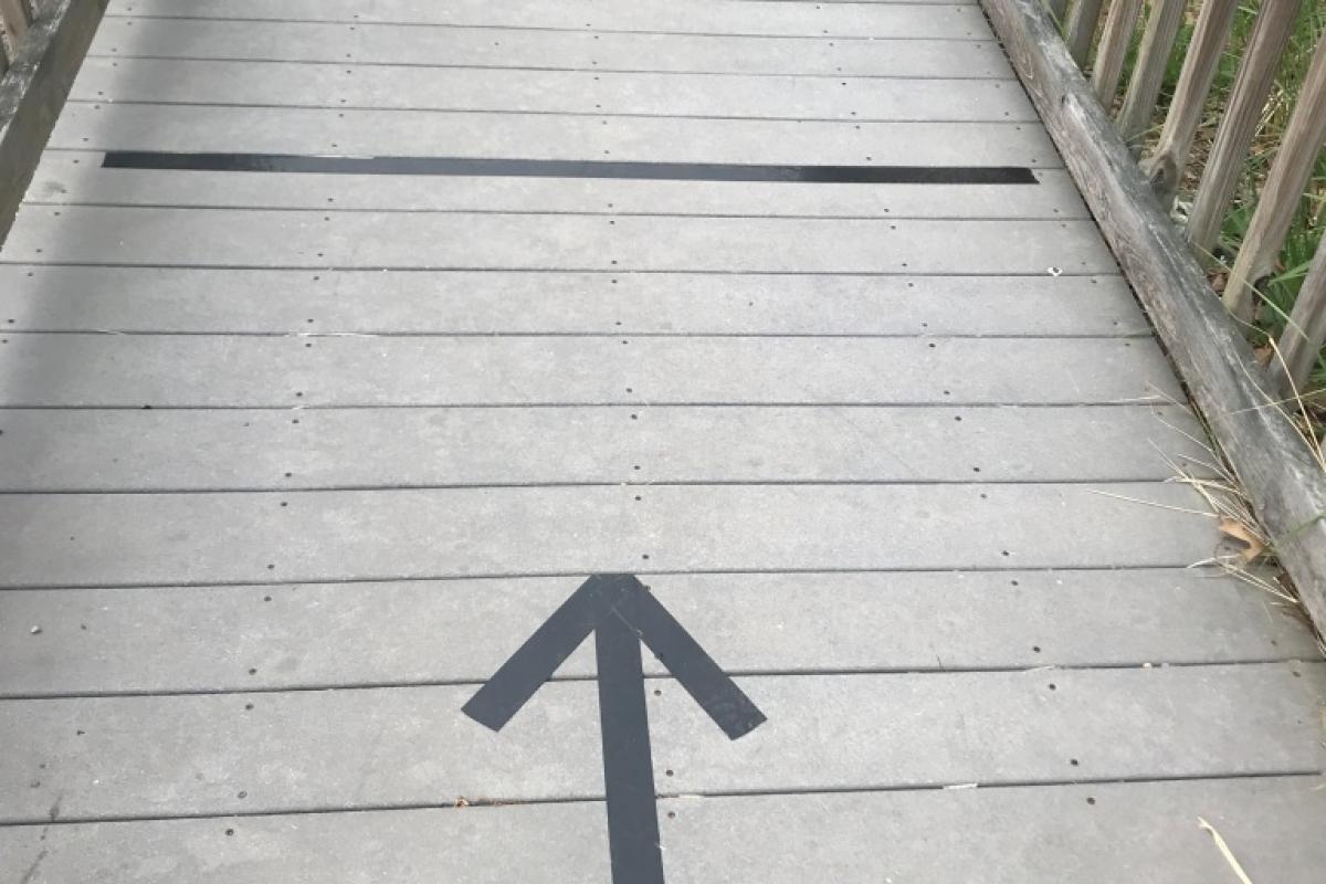 Arrow on ramp indicating walking direction